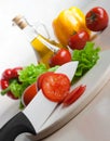 White ceramic knife in action, tomatoes chopping