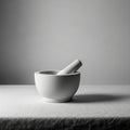 White ceramic mortar and pestle set rests on a textured fabric covered surface Royalty Free Stock Photo