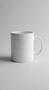 White ceramic mug with a cylindrical shape and a rounded handle. It is set against a Royalty Free Stock Photo