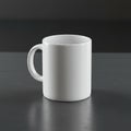 White ceramic mug on a dark, smooth surface with a subtly reflective finish. The mug Royalty Free Stock Photo