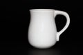White ceramic mug isolated on a black background Royalty Free Stock Photo