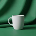 A white ceramic mug placed on a green surface with a matching green backdrop Royalty Free Stock Photo