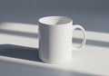 White ceramic mug with a round shape and a sturdy handle, placed on Royalty Free Stock Photo