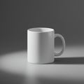 White ceramic mug with a simple cylindrical design and a loop handle, placed on a Royalty Free Stock Photo