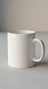 White ceramic mug with a smooth surface, cylindrical shape, and a sturdy handle on Royalty Free Stock Photo