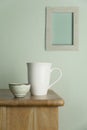 White ceramic mug and tea cup on nature wood table with vintage blue cement and grey picture frame wall for food drink and Royalty Free Stock Photo