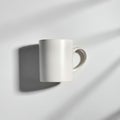White ceramic mug with a textured surface, positioned on a smooth, neutral Royalty Free Stock Photo