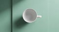 White ceramic mug viewed from above placed on a light green surface Royalty Free Stock Photo