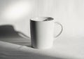 White ceramic mug on a white surface with soft shadows, Royalty Free Stock Photo