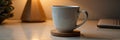 White ceramic mug on wooden coaster in cozy ambient lighting Royalty Free Stock Photo