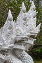 White ceramic naga snake statue on stair of temple