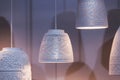 White ceramic pendant lights, chandeliers with ethnic patterns with a light bulb inside. Beautiful white lamps