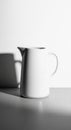 A white ceramic pitcher sits on a flat surface, casting a distinct shadow on a white Royalty Free Stock Photo