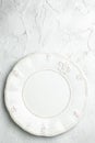 White ceramic plate on a light background, vertical image. top view. place for text Royalty Free Stock Photo