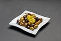 White ceramic plate with marinated olives, pepper and spice salad Royalty Free Stock Photo