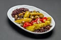 White ceramic plate with marinated olives, stuffed with feta pepper and spice mix Royalty Free Stock Photo