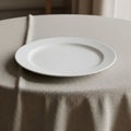 A white ceramic plate sits centered on a table covered with a beige, textured Royalty Free Stock Photo
