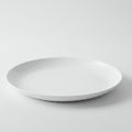 White ceramic plate with a smooth, glossy finish. It has a subtle curved edge, resting on Royalty Free Stock Photo