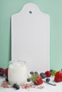 White ceramic serving board, yogurt and berry over light blue ba