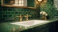 White ceramic sink with two gold taps in a stylish luxury bathroom. Green tile walls, gold-framed mirror, wall lamp