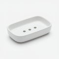 White ceramic soap dish with a rectangular shape featuring rounded edges. It has Royalty Free Stock Photo