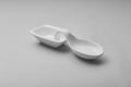 A white ceramic spoon rest sits on a light gray surface Royalty Free Stock Photo