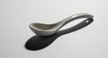 A white ceramic spoon rests on Royalty Free Stock Photo