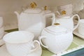 White ceramic tea service in set on shelve