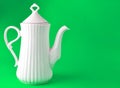 White ceramic teapot on blue background, copy space. Royalty Free Stock Photo