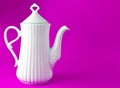 White ceramic teapot on blue background, copy space. Royalty Free Stock Photo