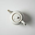 White ceramic teapot with a glossy finish, viewed from above. Features include a round Royalty Free Stock Photo