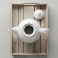 White ceramic teapot with lid on a rustic rectangular wooden tray Royalty Free Stock Photo