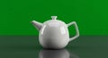 A white ceramic teapot sits centered on a reflective gray surface against a bright green Royalty Free Stock Photo