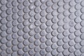 White ceramic tile wall with many small round unique pattern. Top view of bathroom wall tile is a round button tile. Circle white Royalty Free Stock Photo