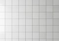White ceramic tiles arranged in a grid pattern, each square being uniform in size. The tiles have a Royalty Free Stock Photo