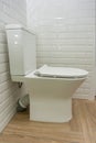 White ceramic toilet bowl in the bathroom interior close-up Royalty Free Stock Photo