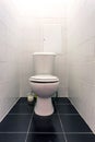 White ceramic toilet bowl in restroom Royalty Free Stock Photo