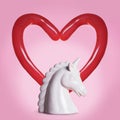 White ceramic unicorn head and a heart made with balloon sticks on a pink background