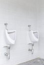 White ceramic urinals in men toilet, interior design Royalty Free Stock Photo