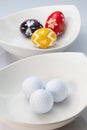 White ceramics bowls, golf balls and eggs Royalty Free Stock Photo