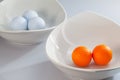 White ceramics bowls and golf balls Royalty Free Stock Photo