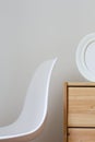 White chair, photo frame on dresser. minimal home interior. modern background Royalty Free Stock Photo