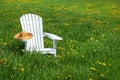 White chair with straw hat