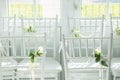 White chairs with flowers for a wedding ceremony. Royalty Free Stock Photo