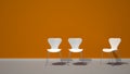 White chairs on orange background