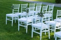 White Chairs at the Outdoor Wedding Ceremony Green Grass Background Party Celebrate Wedding Event Royalty Free Stock Photo