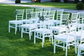 White Chairs at the Outdoor Wedding Ceremony Green Grass Background Party Celebrate Wedding Event Royalty Free Stock Photo