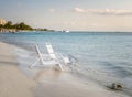 White Chairs on the Shore of a Tropical Beach Royalty Free Stock Photo