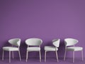 White chairs are standing in an empty violet room.