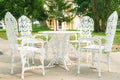 White chairs and table in green park Royalty Free Stock Photo